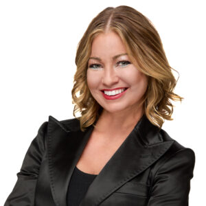 Headshot of Ashley Wooley, a woman in a black suit, exuding professionalism and confidence.